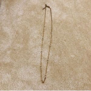 Gold and white colored necklace